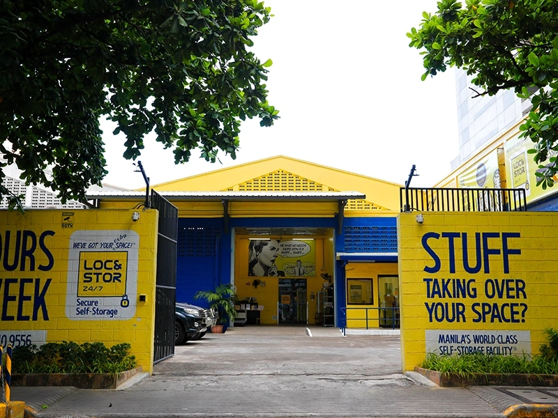 Entrance of Loc&Stor 24/7 secure self-storage facility in Urban Makati, Philippines, with bright yellow and blue walls.